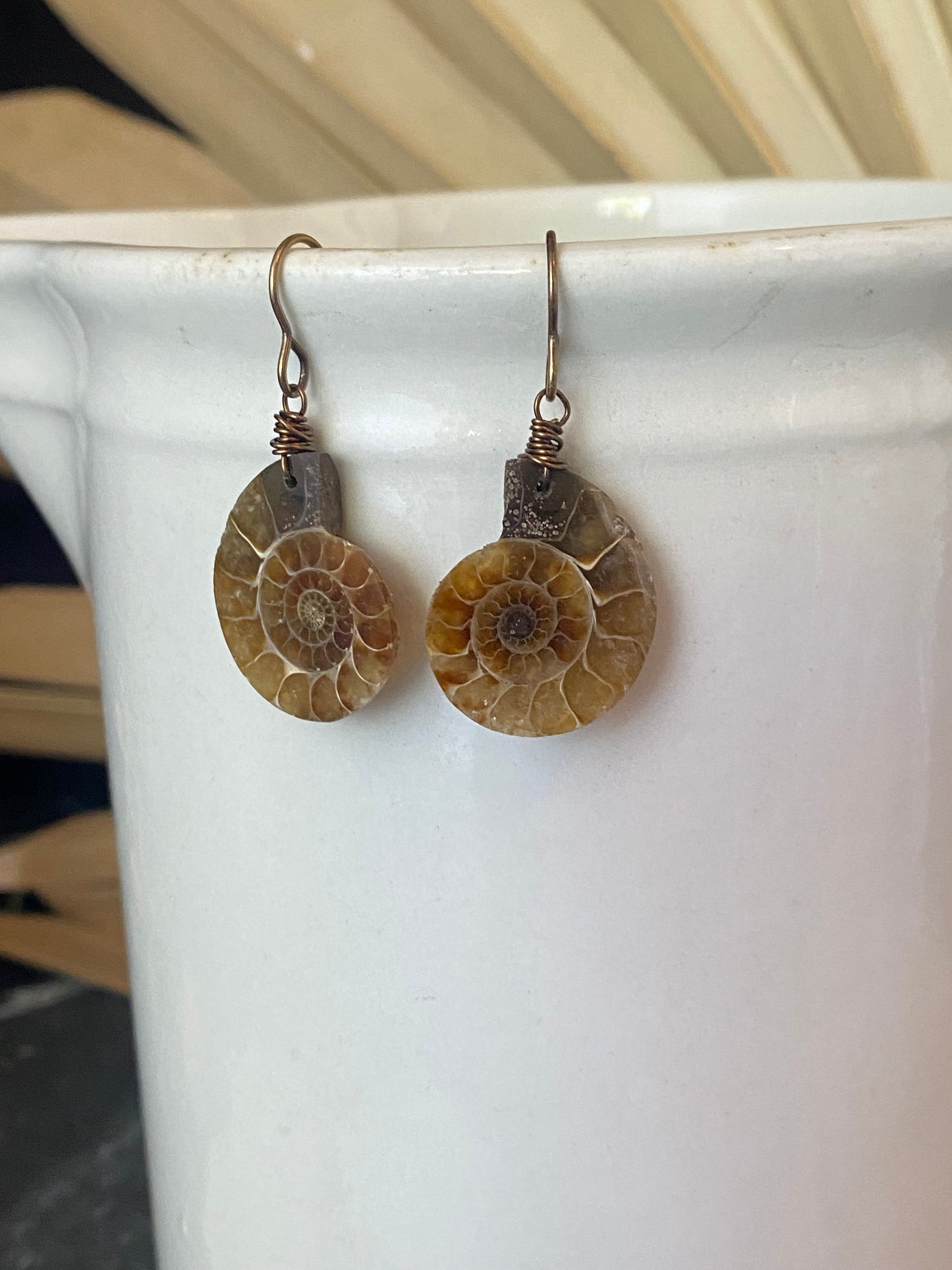 Ammonite stone, bronze metal earrings, jewelry.