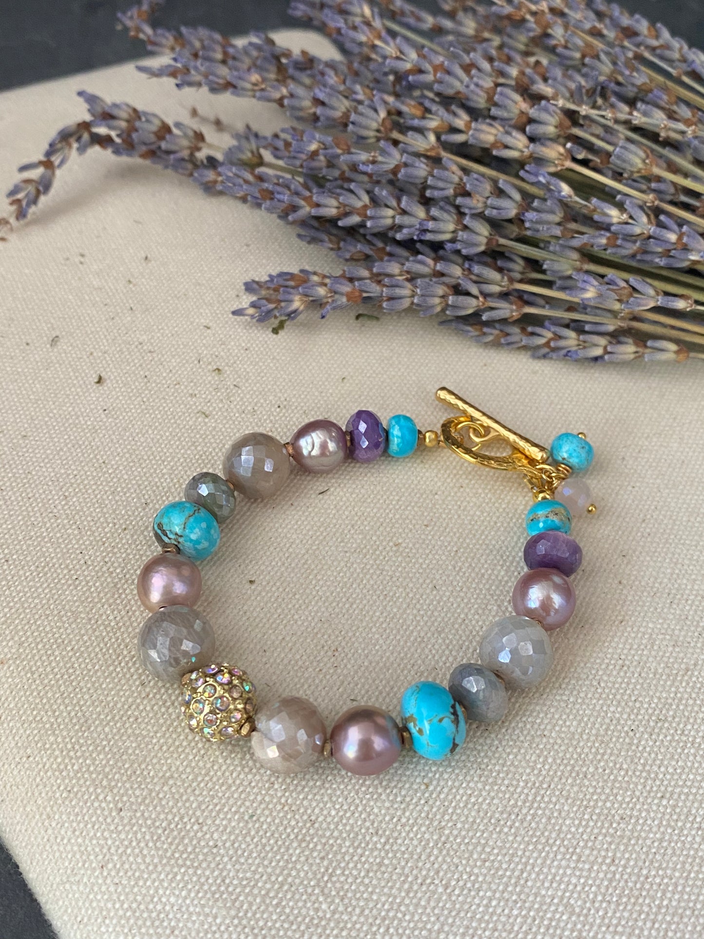 Pink pearls, blue turquoise stone, mystic moonstone, gold metal, bracelet.